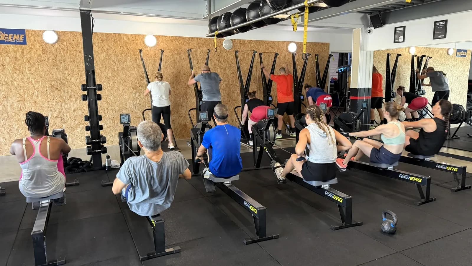 Groupe en entraînement HYROX dans la salle Training d’OXYGÈNE avec rameurs et SkiErg.
